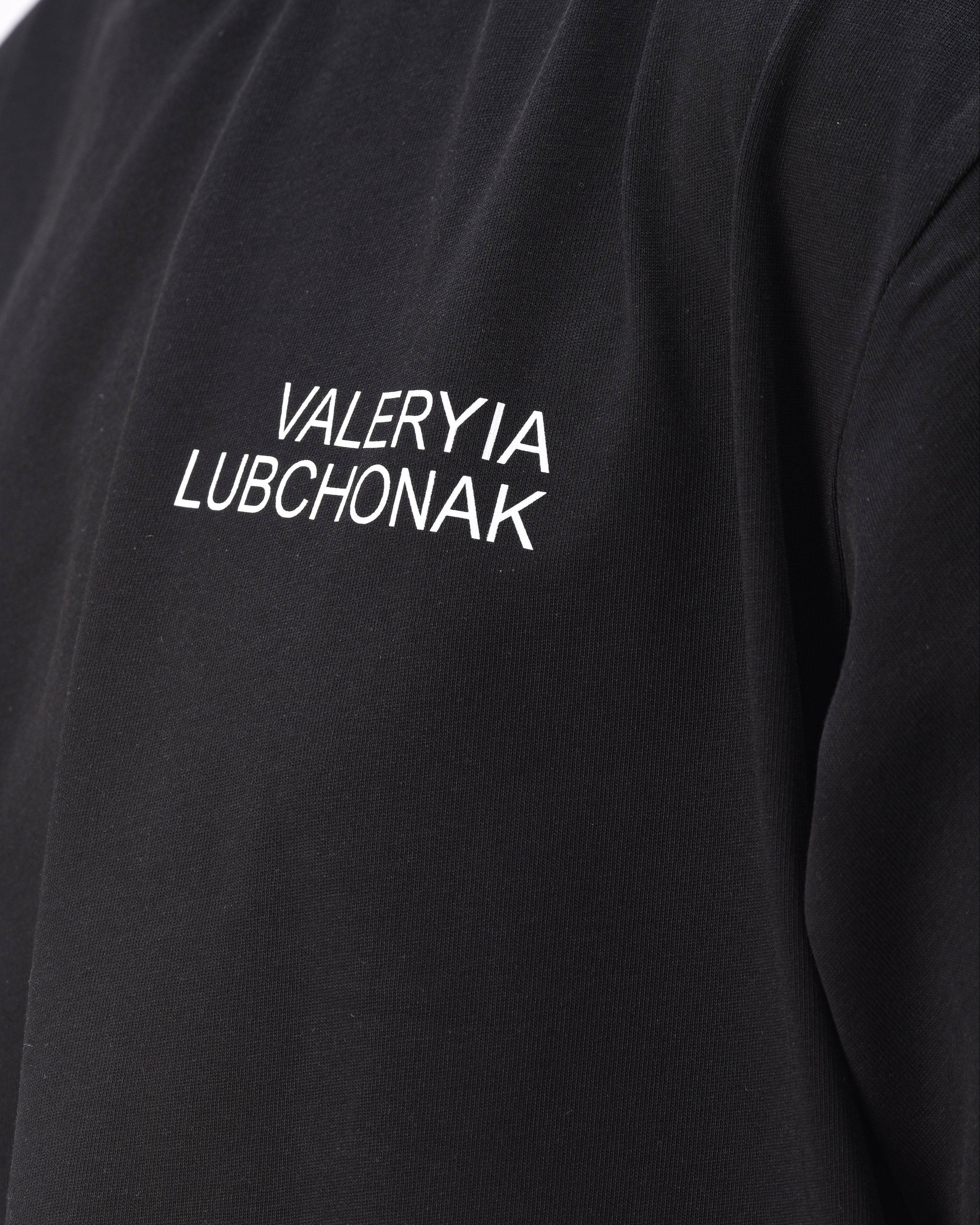 A black t-shirt with the words "Valeryia Lubchonak" on the left part of the top of the chest, and the "Lubchonak" logo on the bottom corner, close up.