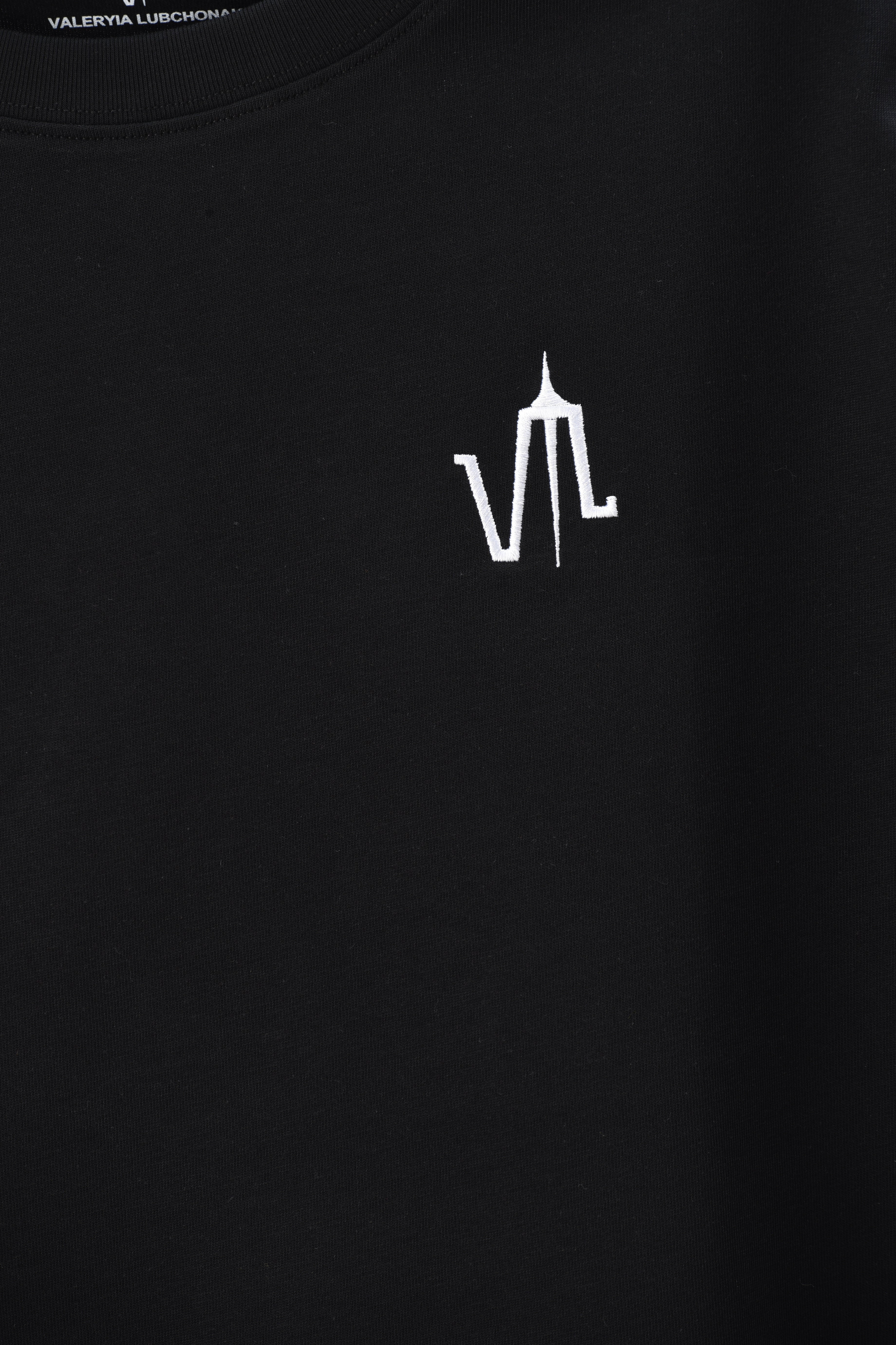 A black t-shirt with the "lubchonak" logo embroidered on the front, close-up.