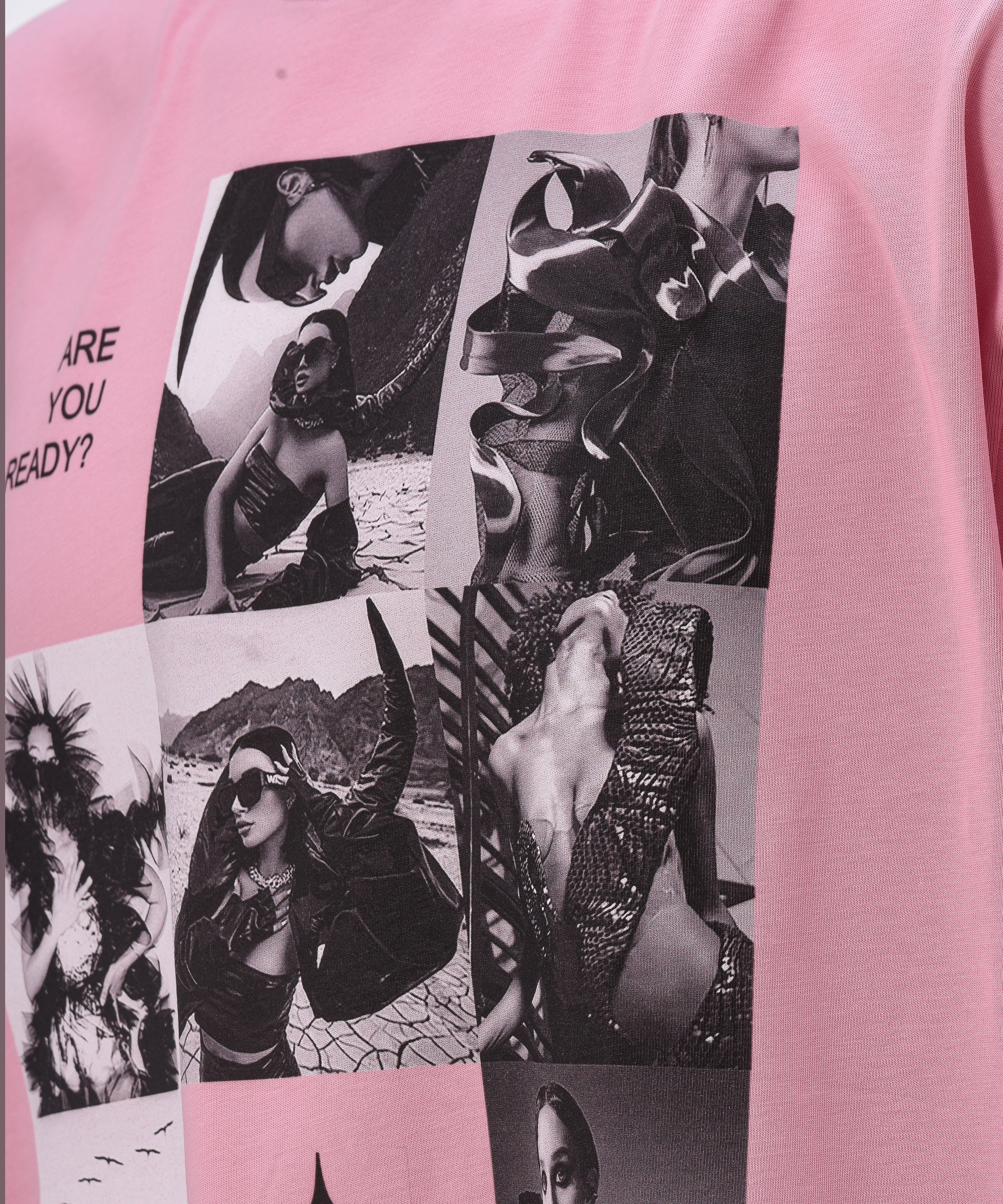 A pink t-shirt, viewed from the front, with a big print of a photo montage and elements of the brand Valeryia Lubchonak, close-up.