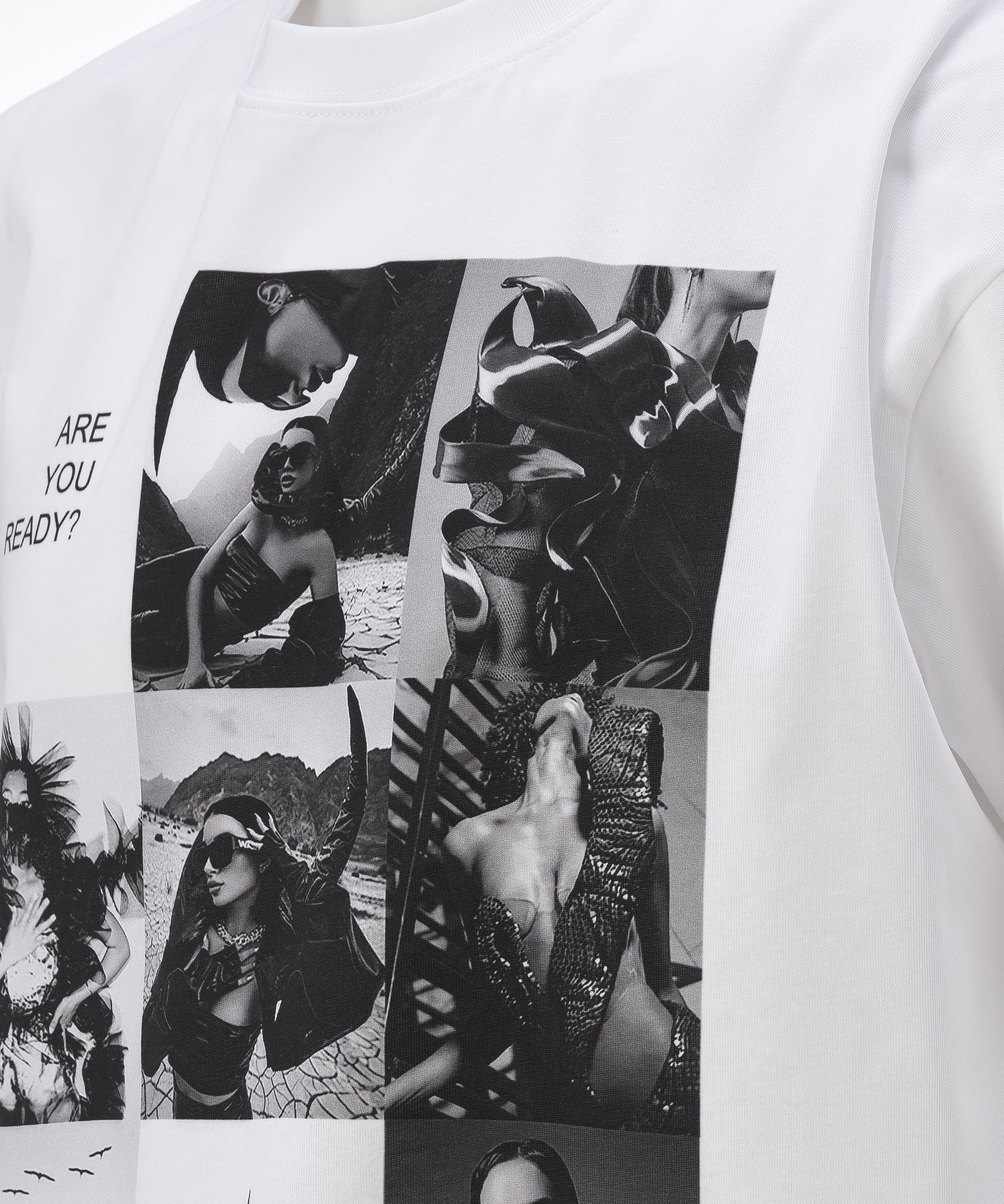 A white colored t-shirt, viewed from the front, with a big print of a photo montage and elements of the brand Valeryia Lubchonak, close up.