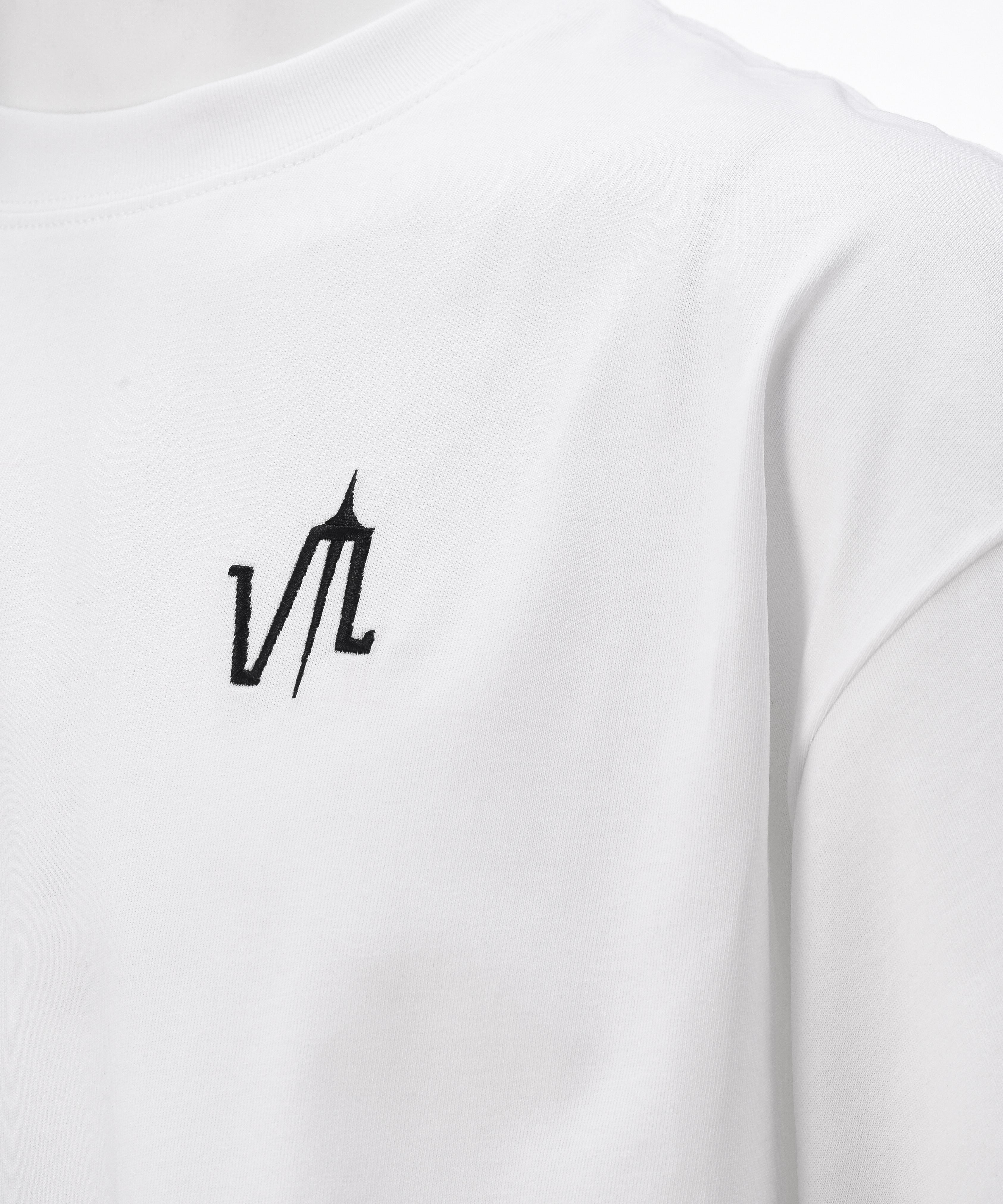 A white t-shirt with the "lubchonak" logo embroidered on the front, close-up.